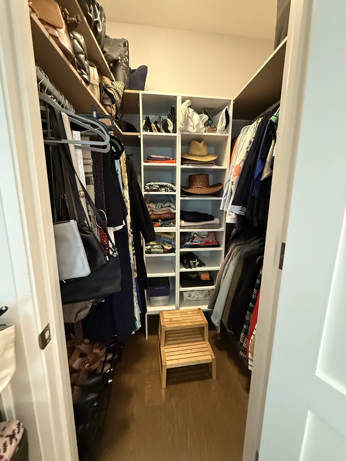 Walk-in closet after professional home organizing in the GTA - Chaos Meets Order