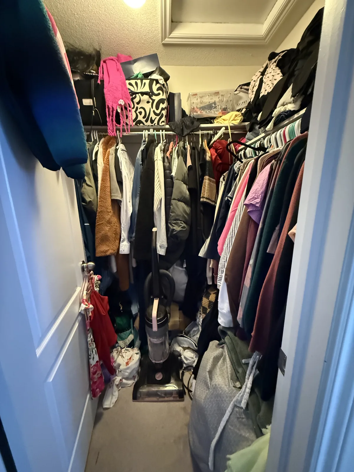 Walk-in closet before professional home organizing in the GTA - Chaos Meets Order